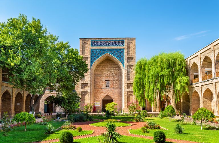 Red Brick Structure and Green Grass and Trees in Uzbekistan