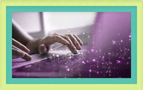 a person typing on a laptop with a purple background