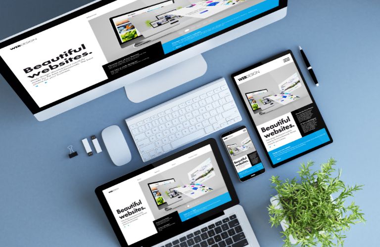 Computer, Laptop, Tablet, and Smartphone with Website Design on Screens