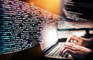 Person on Laptop with Code in the Background