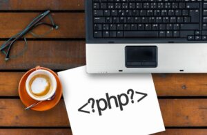 PHP Code on Paper with Coffee Cup and Laptop on a Desk