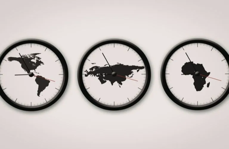 Three wall clocks with black frames displaying world maps of the Americas, Eurasia, and Africa on white faces.