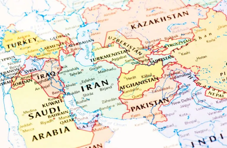 Close-up of a colorful political map showing Middle Eastern and Central Asian countries with labeled borders and cities.