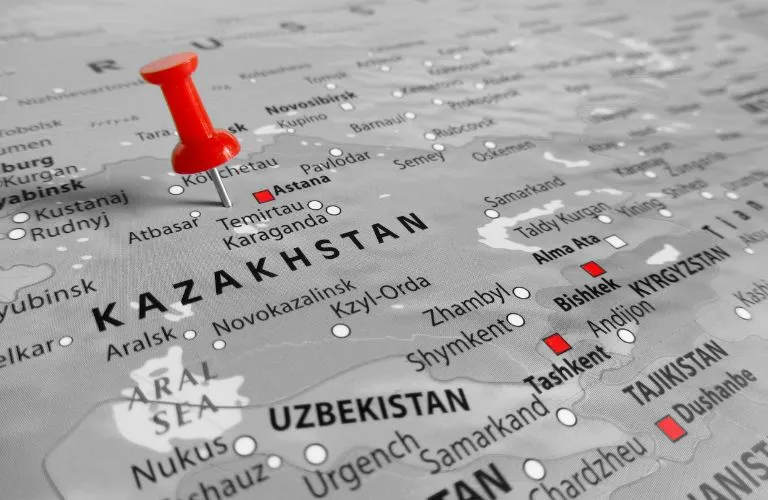 Map of Kazakhstan with a red pushpin marking the capital, Astana, and surrounding cities.