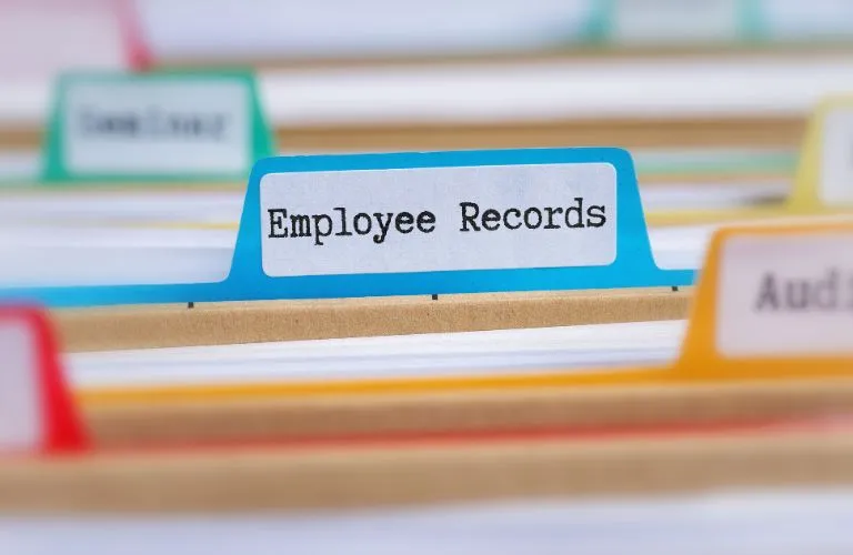 Close-up of colorful file folder tabs with "Employee Records" label in focus.