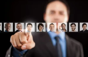Businessman in suit selecting a profile picture from a row of diverse professional headshots.
