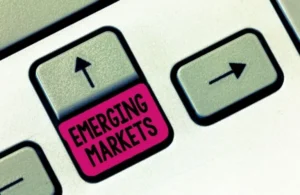 Close-up of a keyboard key labeled "EMERGING MARKETS" in magenta between two arrow keys.