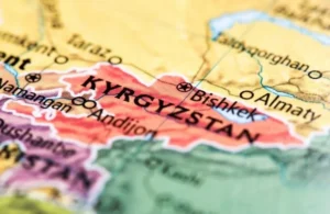 Close-up of a colorful map highlighting Kyrgyzstan and the city of Bishkek.