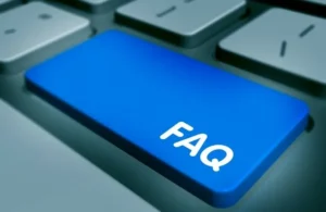 Close-up of a computer keyboard featuring a prominent blue key labeled "FAQ" in white text.